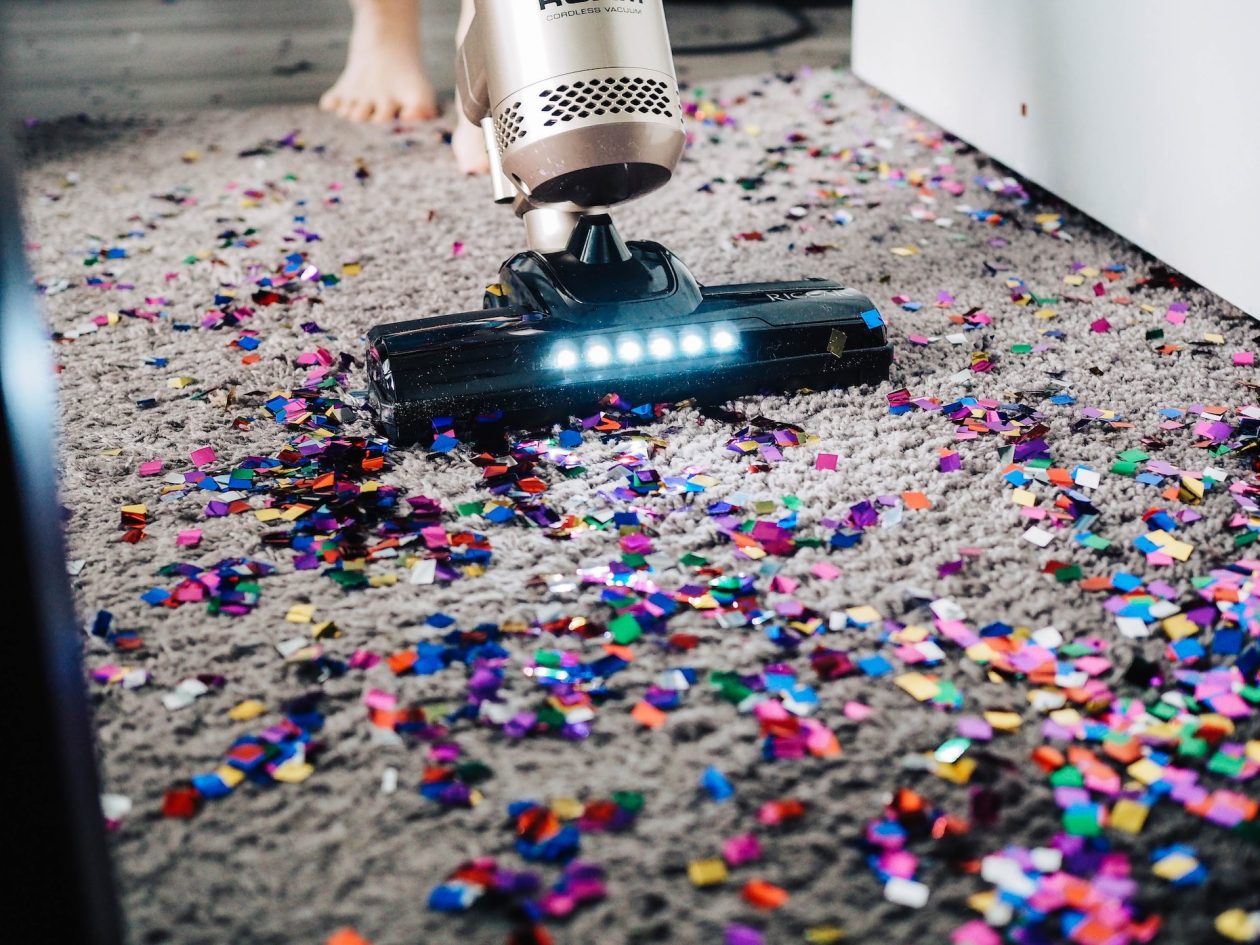Vacuuming a carpet after a party